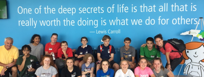 A group of youth on a mission trip with a quotation from Lewis Carroll above their heads